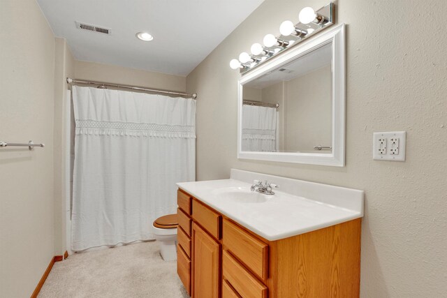 bathroom featuring toilet, vanity, baseboards, visible vents, and a shower with curtain