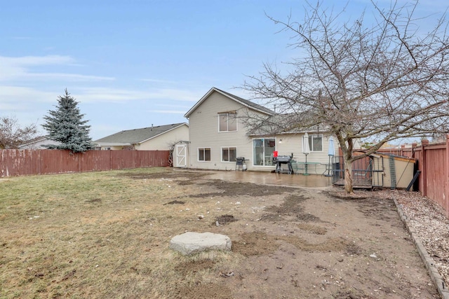 rear view of house featuring a patio area, an outdoor structure, and a storage unit