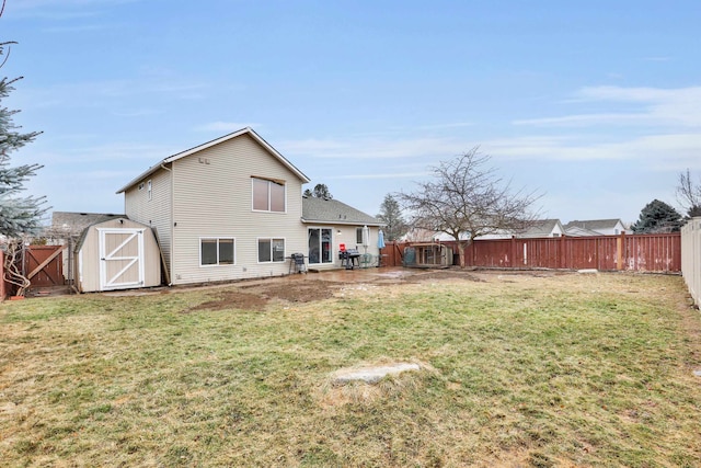 back of property featuring a shed, a lawn, a fenced backyard, and an outdoor structure