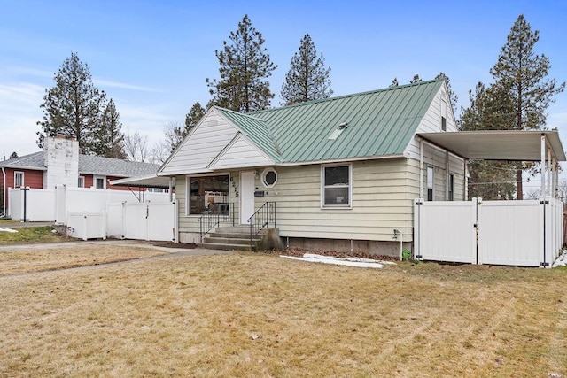 view of front of house featuring a gate, fence, and metal roof