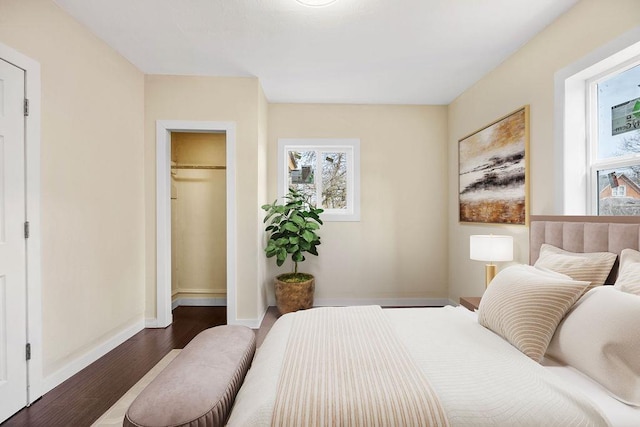 bedroom with baseboards and wood finished floors