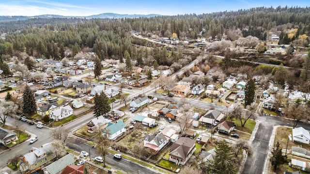 aerial view featuring a forest view and a residential view