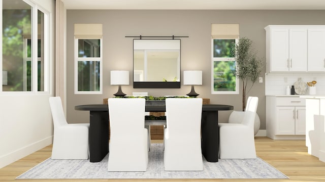 dining room with light wood-type flooring and baseboards