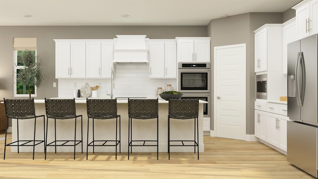 kitchen with appliances with stainless steel finishes, backsplash, white cabinets, and light wood-style floors