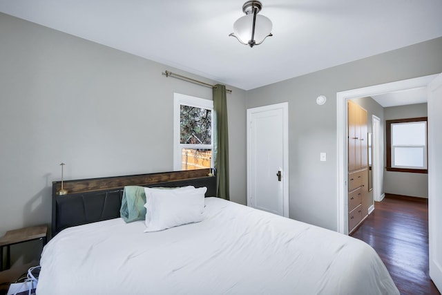 bedroom with dark wood-type flooring