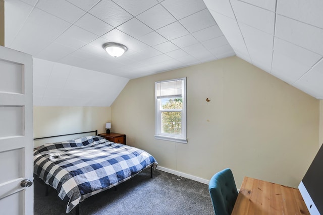 carpeted bedroom with lofted ceiling and baseboards