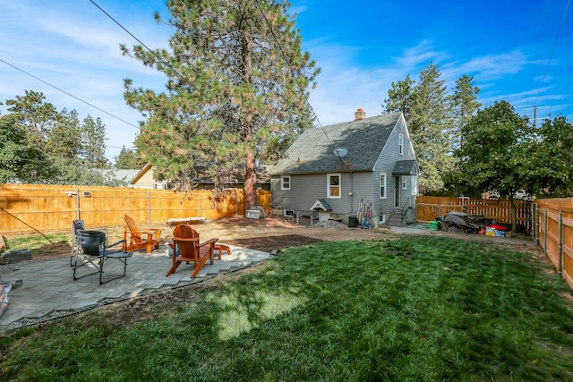 view of yard featuring entry steps, a fenced backyard, and a patio