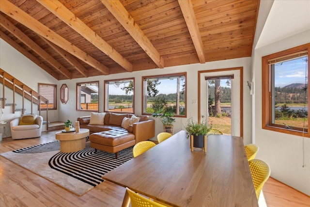 interior space with stairway, wooden ceiling, lofted ceiling with beams, and wood finished floors