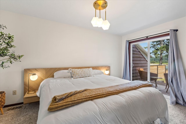 carpeted bedroom with access to outside and baseboards