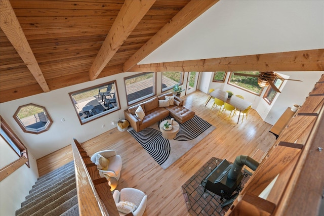 unfurnished living room featuring high vaulted ceiling, wood ceiling, beam ceiling, and wood finished floors