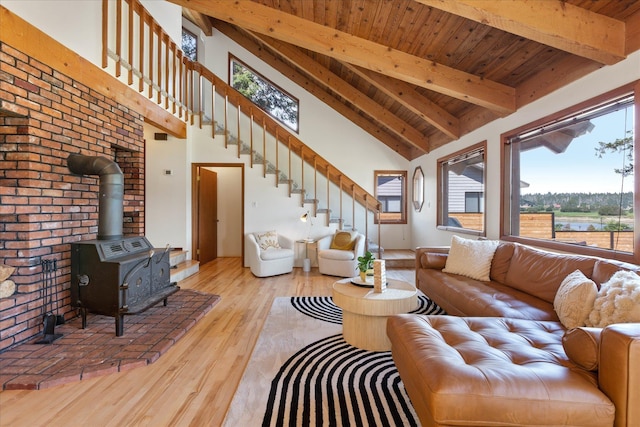 living room with wood finished floors, wood ceiling, stairway, beamed ceiling, and a wood stove