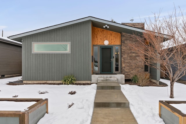 view of snow covered property entrance