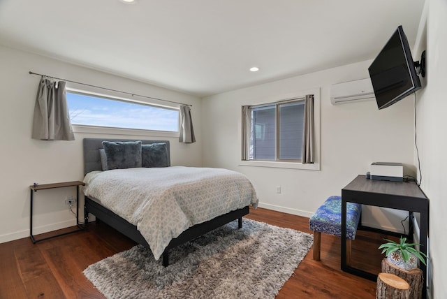 bedroom featuring recessed lighting, baseboards, wood finished floors, and a wall mounted AC