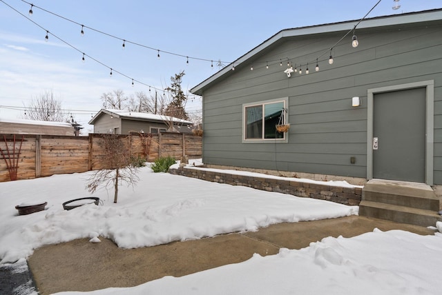 snowy yard with fence