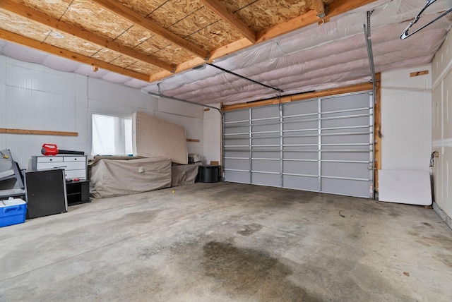 snow covered garage featuring fence