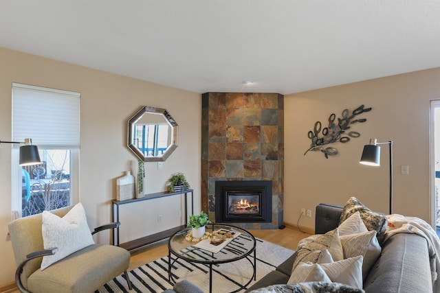 living room featuring light wood finished floors and a fireplace