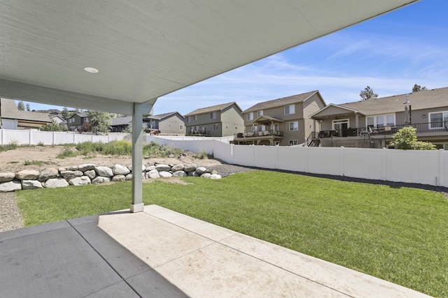 view of yard with a residential view, a patio area, and a fenced backyard