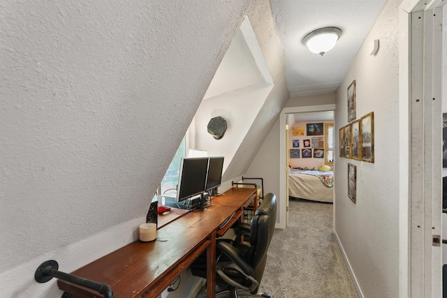 office space featuring a textured wall, carpet floors, a textured ceiling, and baseboards