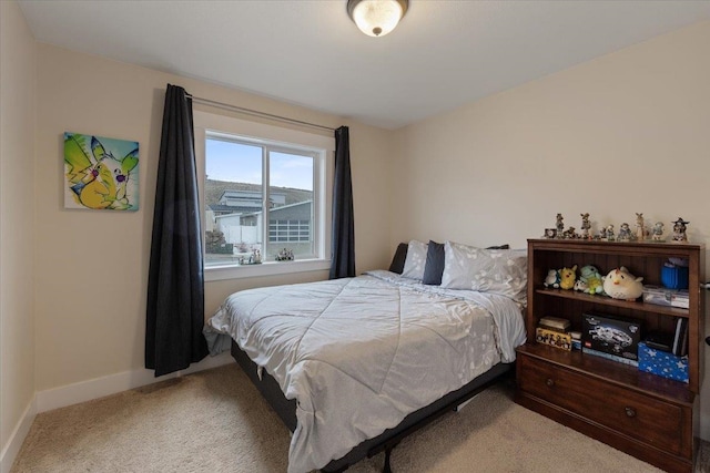 bedroom featuring carpet and baseboards