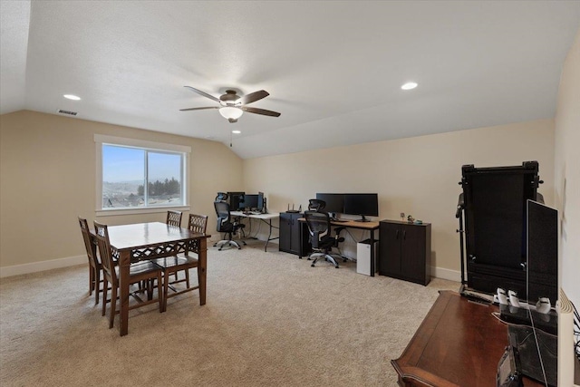 office space featuring light carpet, baseboards, vaulted ceiling, and a ceiling fan