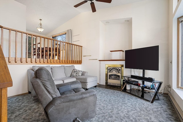 carpeted living room with ceiling fan, baseboards, vaulted ceiling, and a tiled fireplace