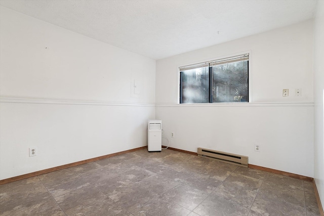 unfurnished room featuring baseboard heating and baseboards