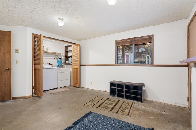 interior space with washer and clothes dryer, a textured ceiling, and unfinished concrete floors