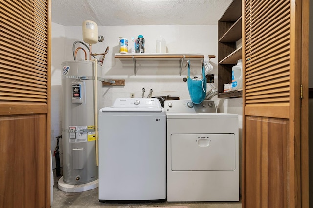 laundry area with secured water heater, washer and clothes dryer, a textured ceiling, and laundry area