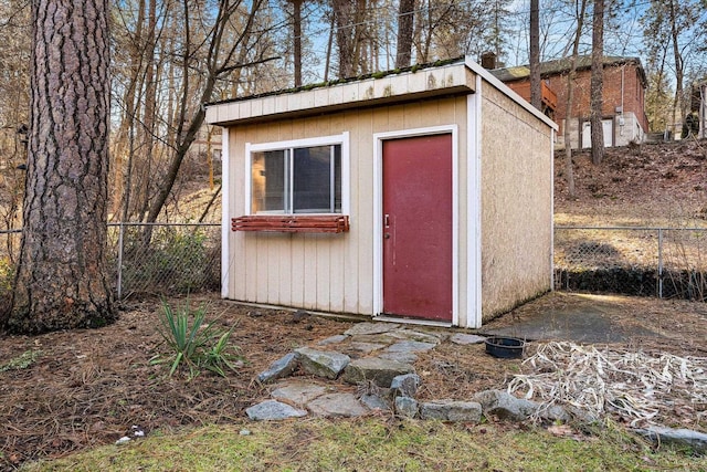 view of shed featuring fence