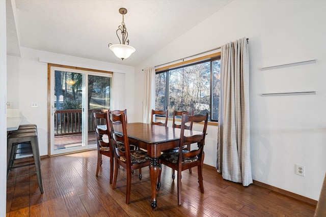 dining area with lofted ceiling, dark wood-style flooring, and baseboards