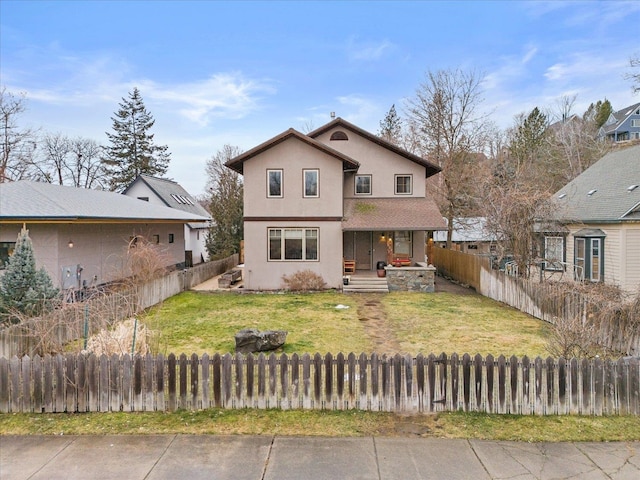 traditional-style home with stucco siding, a fenced front yard, a porch, and a front yard