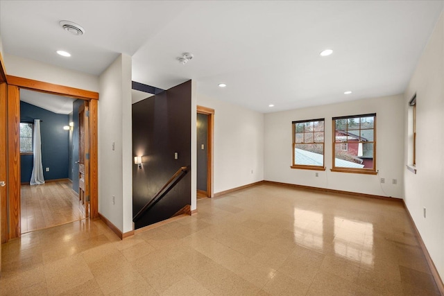 empty room with recessed lighting, visible vents, and baseboards