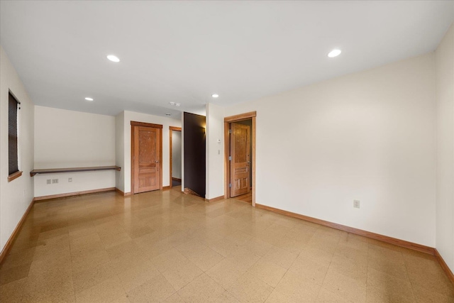 spare room with recessed lighting, baseboards, and light floors