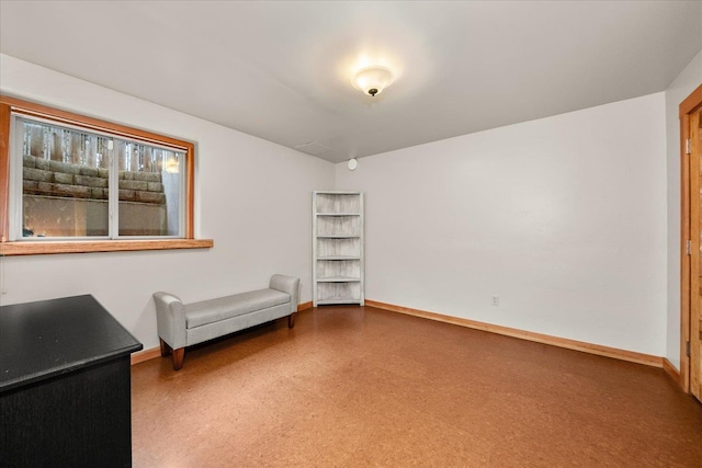 unfurnished room with baseboards