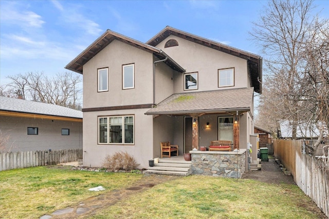 view of front of house featuring a front yard, a porch, and stucco siding