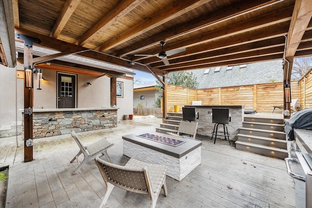 exterior space featuring fence, a fire pit, grilling area, and a ceiling fan