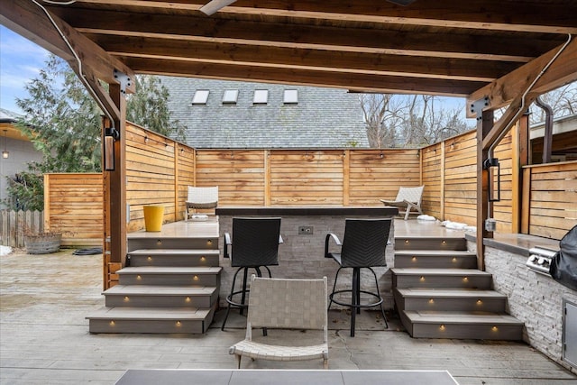 view of patio featuring a fenced backyard and outdoor dry bar