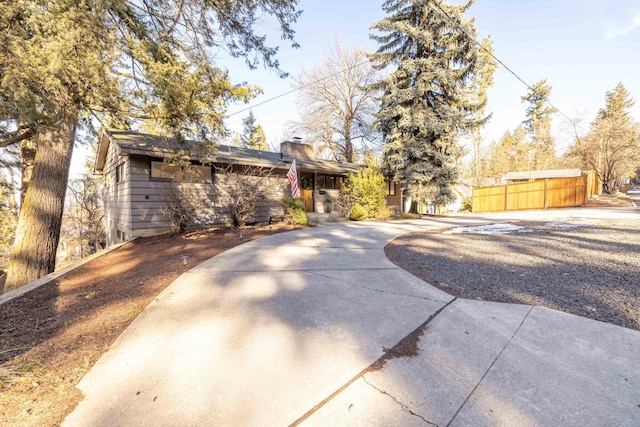 exterior space with a chimney and fence