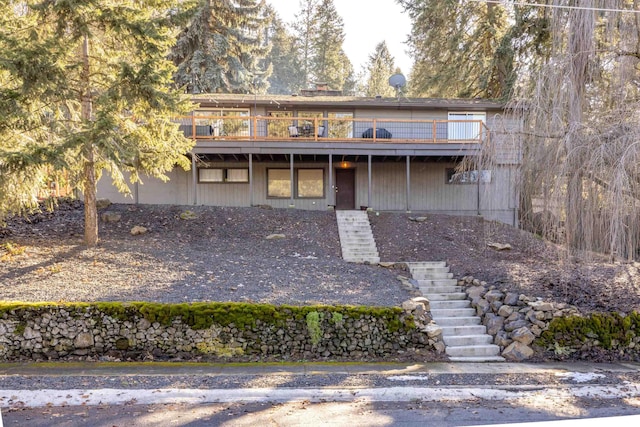 view of front facade with a deck and stairs