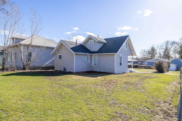 rear view of property with a yard