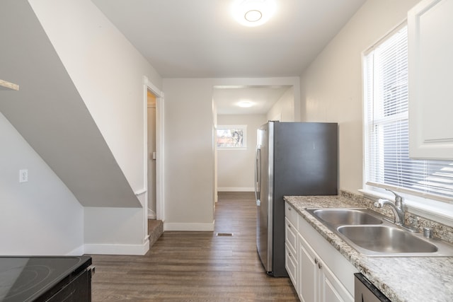 kitchen featuring dark wood-style floors, stainless steel appliances, white cabinets, and a sink