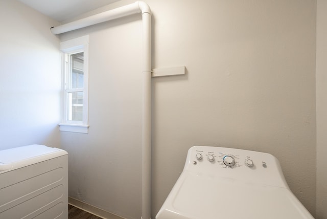 laundry area featuring washer / dryer, laundry area, and dark wood finished floors