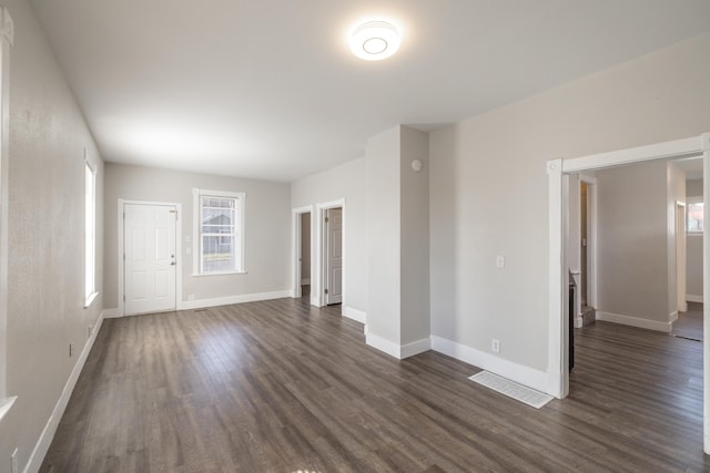 unfurnished room with dark wood-style floors and baseboards