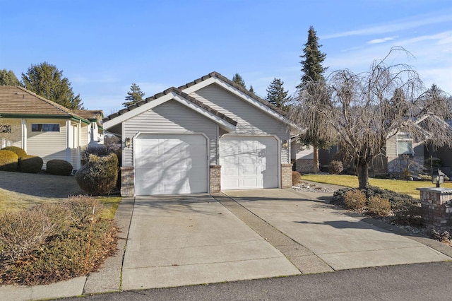 garage featuring concrete driveway