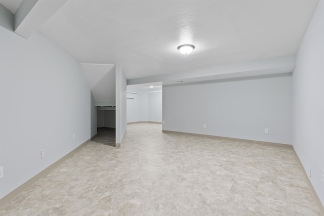 additional living space featuring baseboards