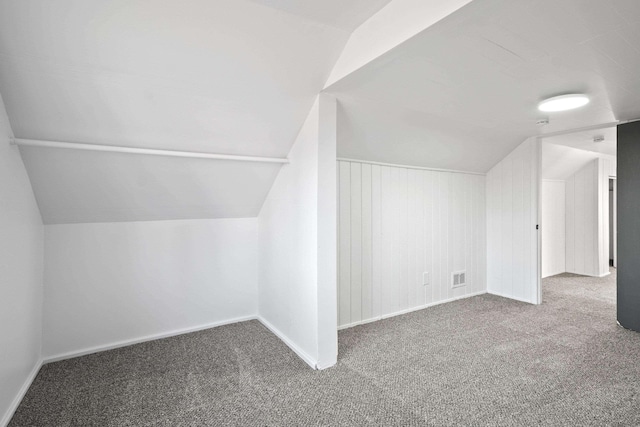 bonus room with lofted ceiling, baseboards, visible vents, and carpet flooring