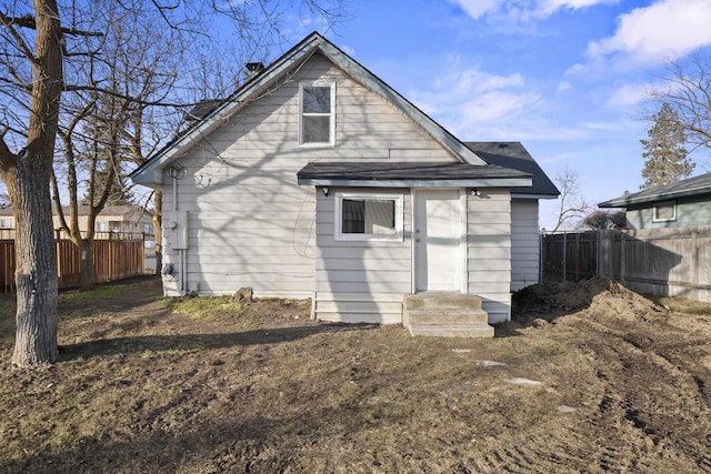 back of house featuring fence