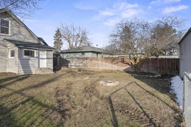 view of yard featuring entry steps and fence