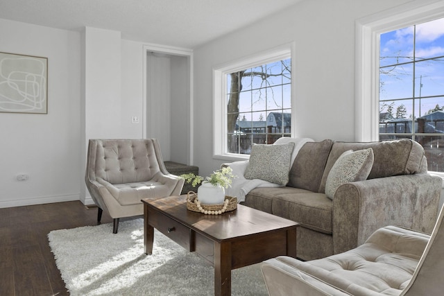 living room featuring baseboards and dark wood finished floors