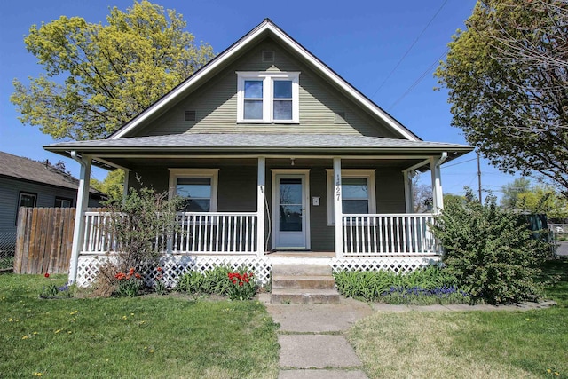 view of front of property with a porch and a front yard